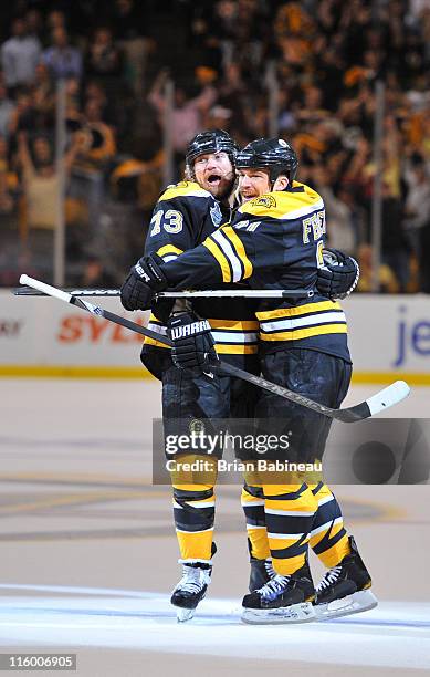 Michael Ryder and Andrew Ference of the Boston Bruins celebrate a goal against the Vancouver Canucks in Game Six of the 2011 NHL Stanley Cup Final at...