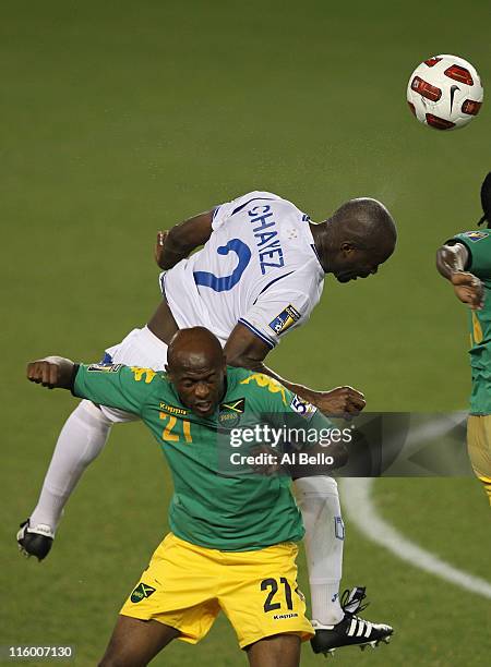 Osman Chavez of Honduras heads the ball over Luton Shelton of Jamaica during the Concaf Gold Cup at Red Bull Arena on June 13, 2011 in Harrison, New...