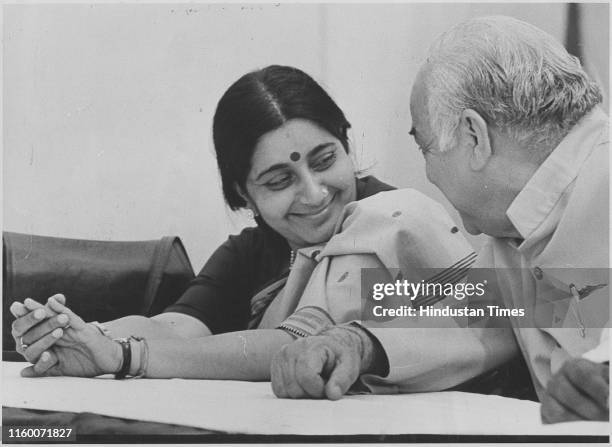 Leaders Sushma Swaraj and Madan Lal Khurana talking to each other during a Press Conference at the party office in New Delhi, India; Former External...