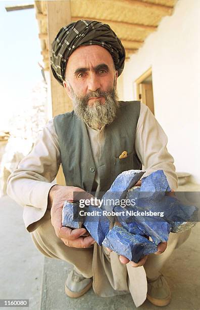 Follower of Afghani opposition leader General Ahmed Shah Massoud displays pieces of lapis lazuli at a Massoud stronghold May 2001 in the Panjshir...