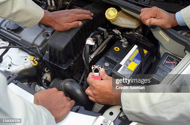 mechanics checking the car engine - car battery stockfoto's en -beelden