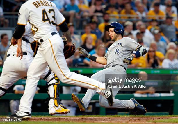 Ryan Braun of the Milwaukee Brewers scores on an RBI double in the fifth inning against the Pittsburgh Pirates at PNC Park on August 6, 2019 in...