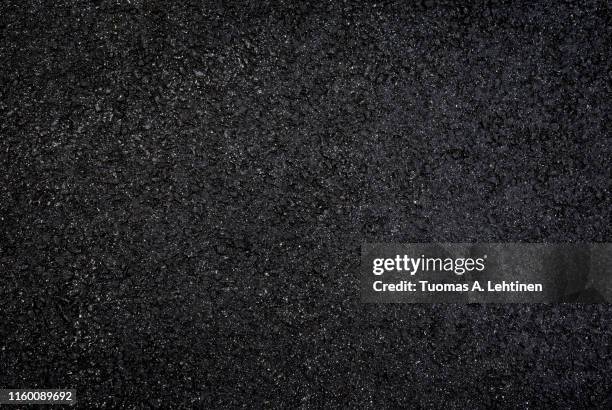 background of wet and dark gray asphalt - wet surface stock pictures, royalty-free photos & images