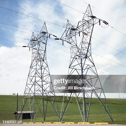 Electricity pylons and power lines near a dam in South Dakota