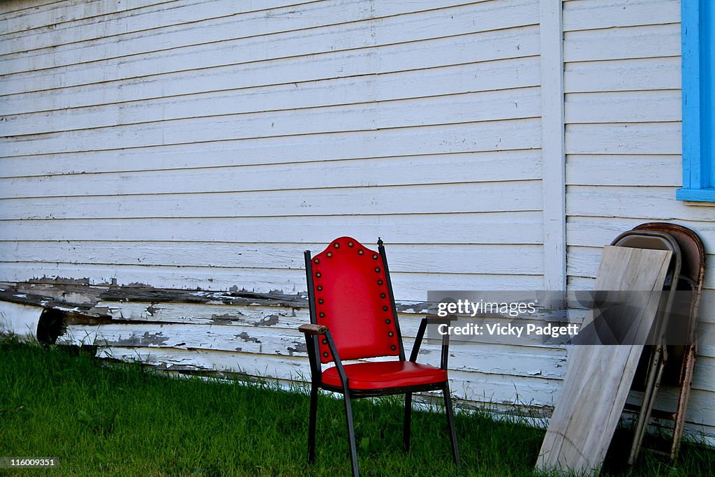Red chair against   white wall