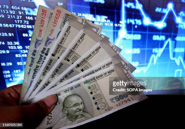 In this photo illustration the Indian currency notes are seen on display. Dollar price made its highest peak against the Indian rupee this week.