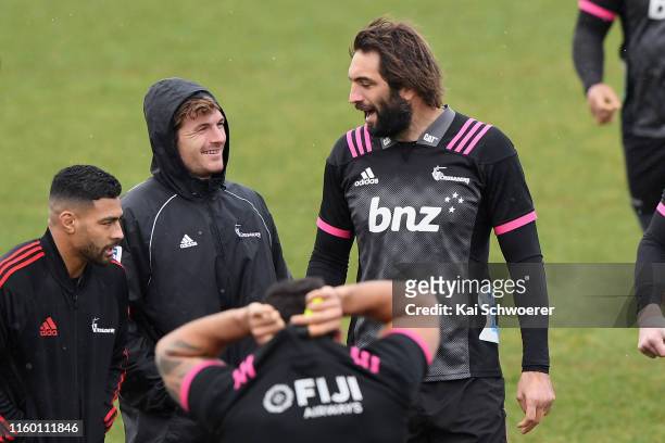 Richie Mo'unga, George Bridge and Samuel Whitelock react during the Crusaders Super Rugby captain's run at Rugby Park on July 05, 2019 in...