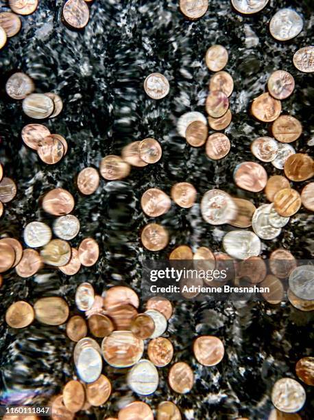 pennies and dimes at the bottom of a coin fountain - water fountain stock pictures, royalty-free photos & images