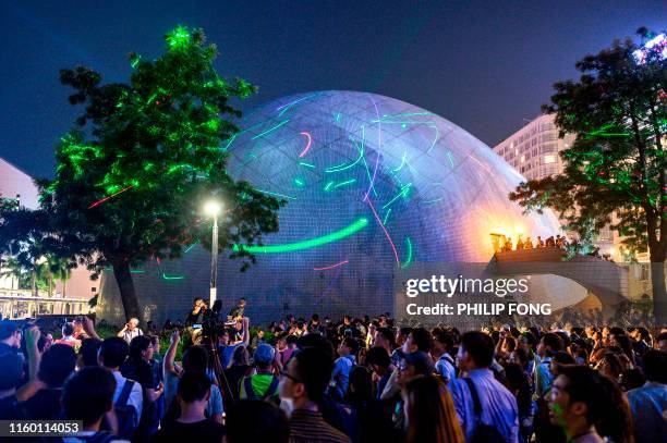 Protesters point lasers at the Space Museum during a demonstration in Hong Kong on August 7 in the latest opposition to a planned extradition law...