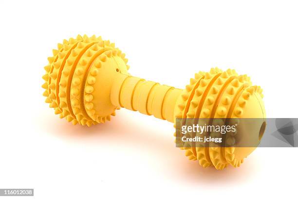 yellow squishy dog toy for clean teeth - dog's toy stockfoto's en -beelden
