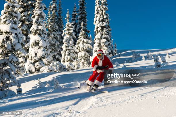 santa claus skiing downhill during christmas - funny snow skiing stock pictures, royalty-free photos & images