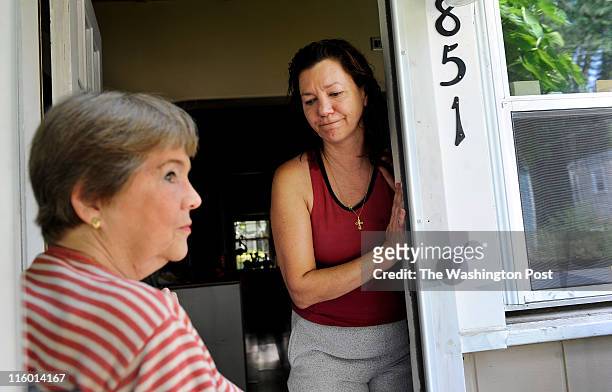 Tabitha Yothers, left, visits the home of neighbor, Lisa Remick on June 08, 2011 in Falls Church, VA. The women are part of small group of residents...