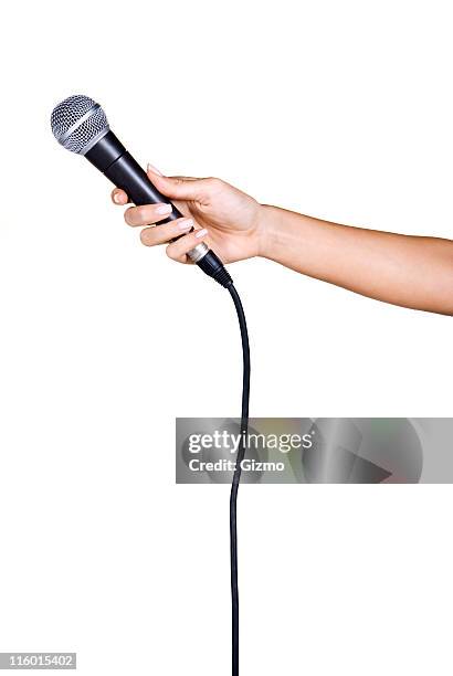 holding a microphone - microphone stock pictures, royalty-free photos & images