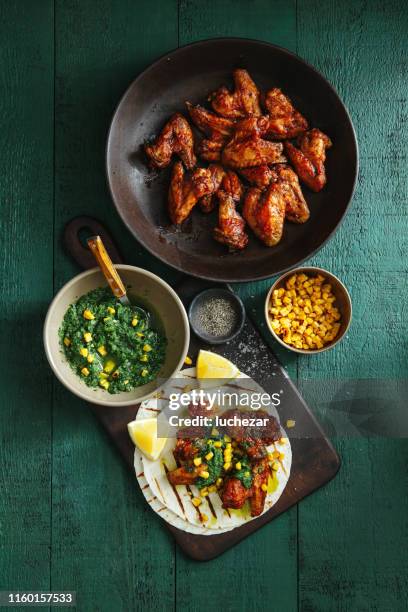 grilled chicken wings with green chilli and corn salsa - bbq chicken wings stock pictures, royalty-free photos & images