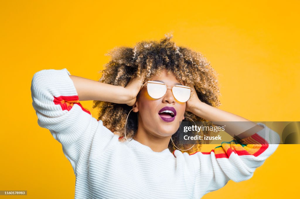 Funky afro girl against yellow background