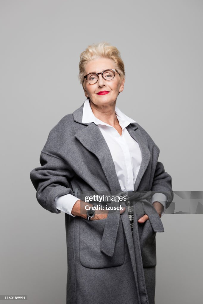 Beautiful senior woman in grey overcoat