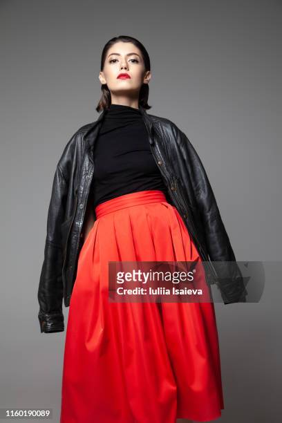 graceful young woman wearing black jacket in studio - art modeling studios stock pictures, royalty-free photos & images