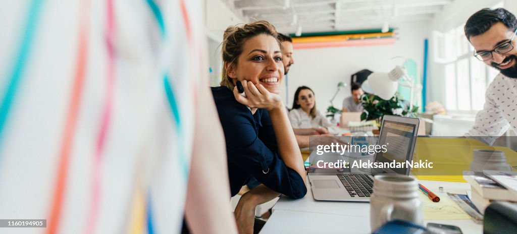 Smiling young woman in the office