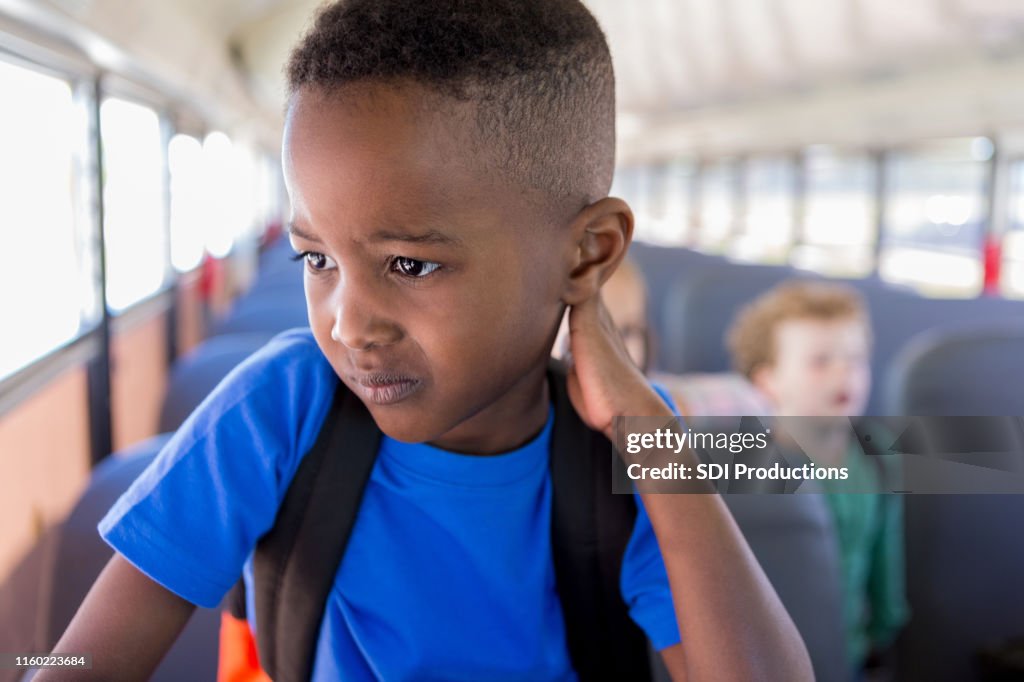 While waiting to get off bus, boy worries about school