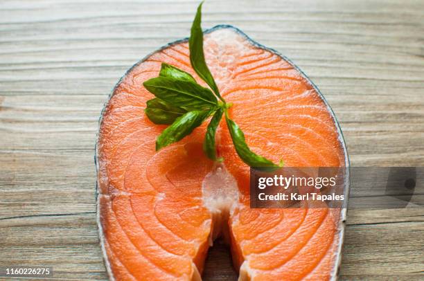 fresh raw salmon steak on a wooden table - salmon steak stock pictures, royalty-free photos & images