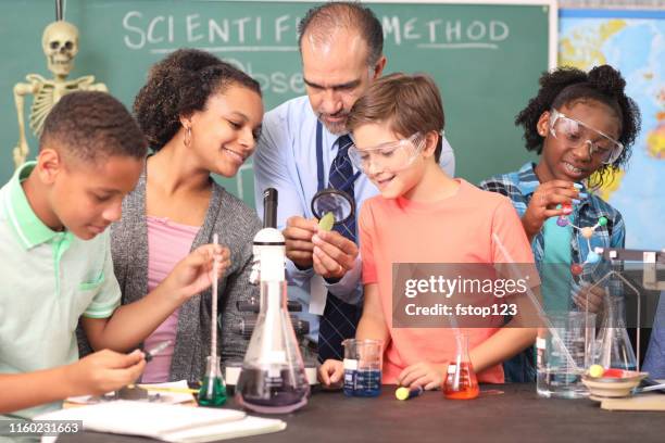 junior high age school students conduct science experiments in classroom. - junior high student stock pictures, royalty-free photos & images