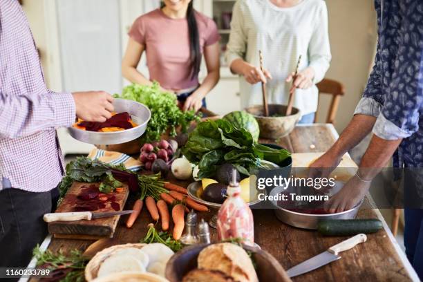 friends preparing and cooking vegan food. - southern europe stock pictures, royalty-free photos & images