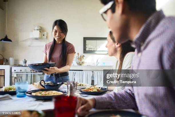 Woman bringing food to the table.