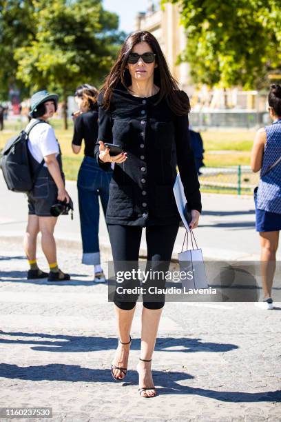 Guest, wearing a black Chanel top, black pants and black sandals, is seen outside Chanel show during Paris Fashion Week - Haute Couture Fall/Winter...