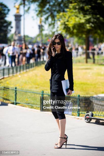Guest, wearing a black Chanel top, black pants and black sandals, is seen outside Chanel show during Paris Fashion Week - Haute Couture Fall/Winter...