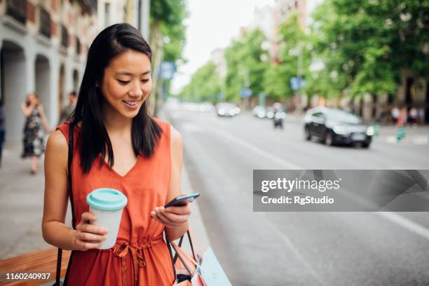 joven caminando por la calle - electronic banking fotografías e imágenes de stock