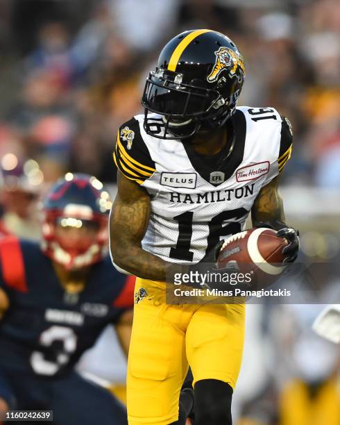 Brandon Banks of the Hamilton Tiger-Cats runs with the ball against the Montreal Alouettes during the CFL game at Percival Molson Stadium on July 4,...