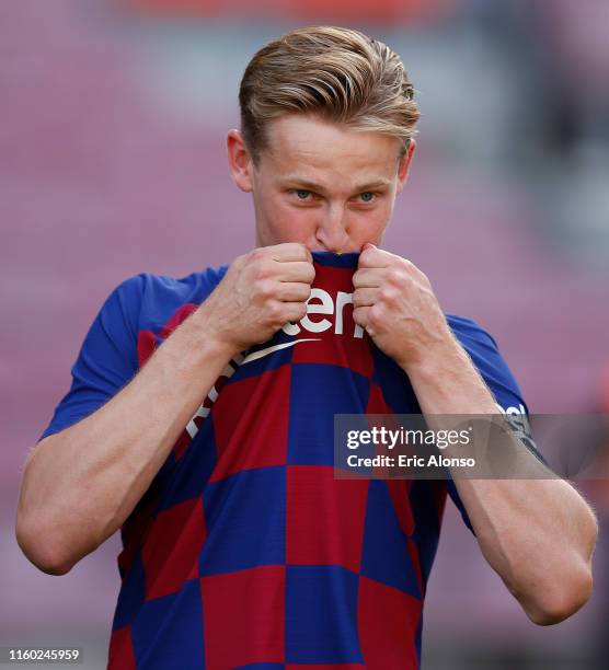 New Barcelona signing Frenkie de Jong kisses the badge as he is unveiled at Camp Nou stadium on July 05, 2019 in Barcelona, Spain.