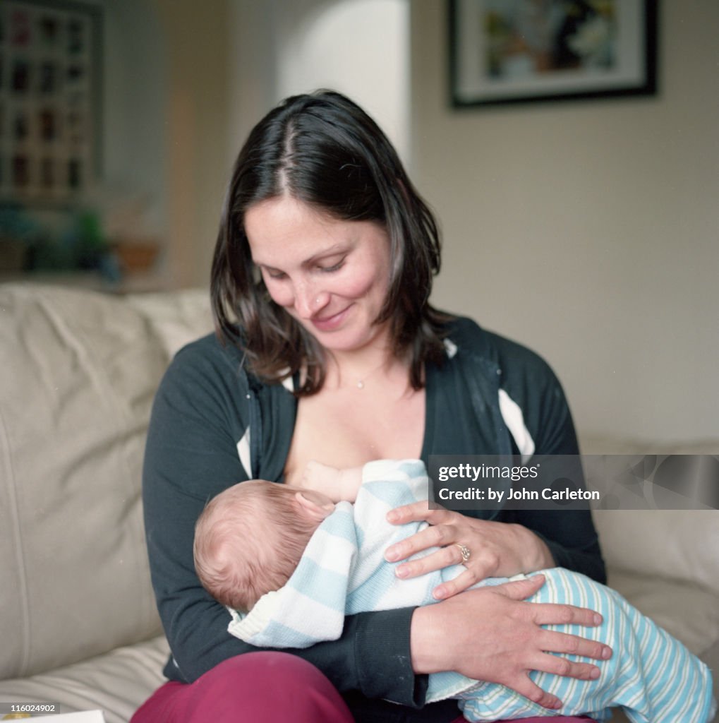 Mother breastfeeds her two-month-old baby boy