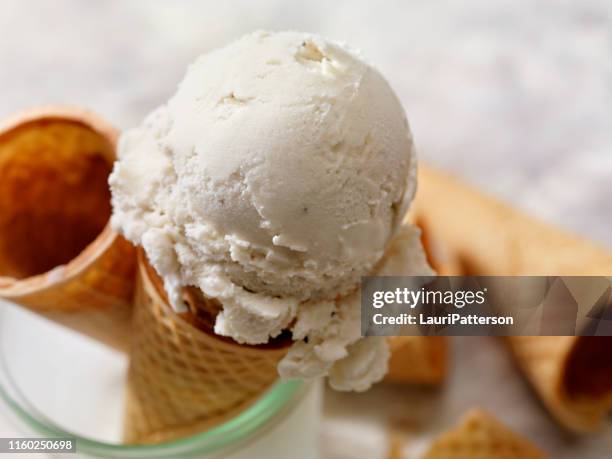 dairy free, coconut milk vanilla ice cream in a sugar cone - ice cream stock pictures, royalty-free photos & images