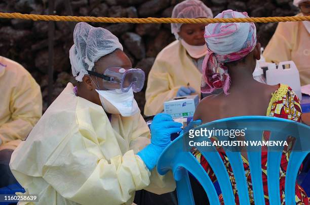 Girl receives a vaccine against Ebola from a nurse in Goma on August 7, 2019. Three cases of the deadly virus was detected in the border city of...