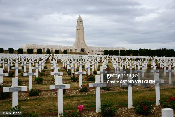 Picture taken on August 6, 2019 shows crosses at the World War I cemetery and the Ossuary of Douaumont , dedicated to the memory of soldiers in the...