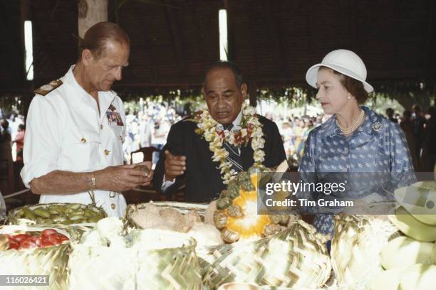 Prince Philip, Hammer DeRoburt , President of the Republic of Nauru, and Queen Elizabeth II inspecting fruit at a garden party, held at the State...