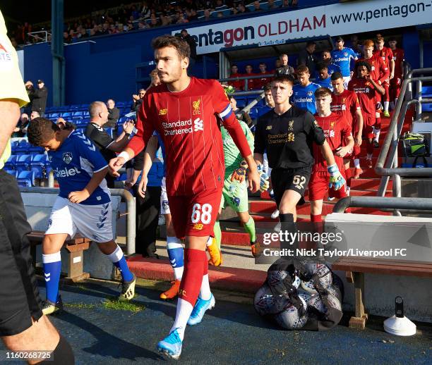 Pedro Chirivella of Liverpool leads his team onto the pitch at the start of the Checkatrade Trophy match at Boundary Park on August 7, 2019 in...