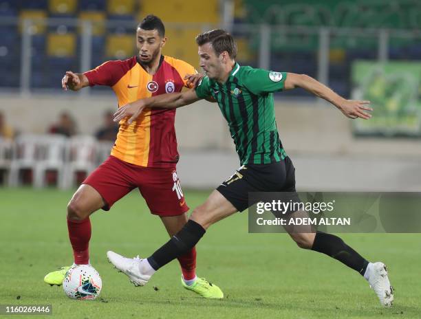 Theodor Elmar Bjarnason of Akhisarspor vies with Younes Belhanda of Galatasaray during the 2019 Turkish Super Cup match between Galatasaray and...