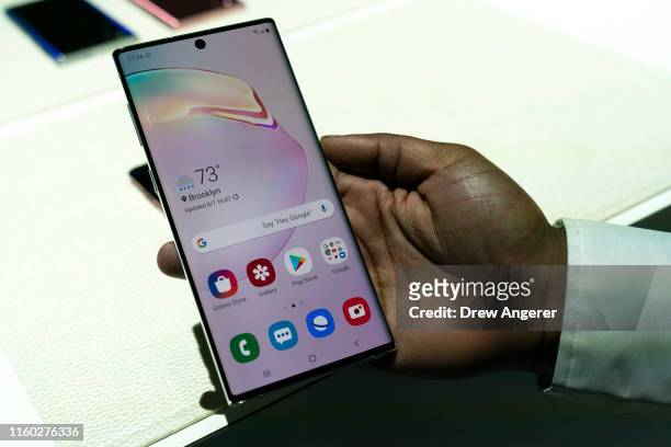 Samsung employee holds the new Samsung Galaxy Note 10 smartphone during a launch event at Barclays Center on August 7, 2019 in the Brooklyn borough...
