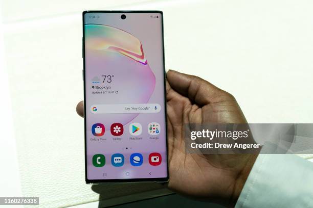 Samsung employee holds the new Samsung Galaxy Note 10 smartphone during a launch event at Barclays Center on August 7, 2019 in the Brooklyn borough...