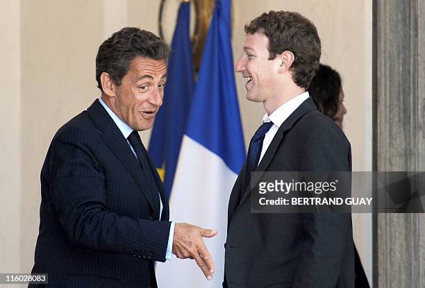 Facebook social networking site founder Mark Zuckerberg speaks with France's President Nicolas Sarkozy as he leaves after a meeting the presidential...
