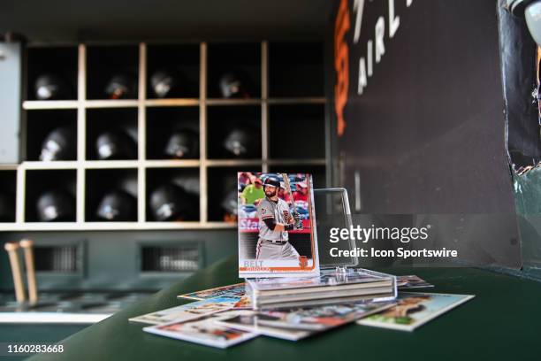 Stack of San Francisco Giants First base Brandon Belt Topps trading cards sitting in the dugout before the MLB game between the Washington Nationals...