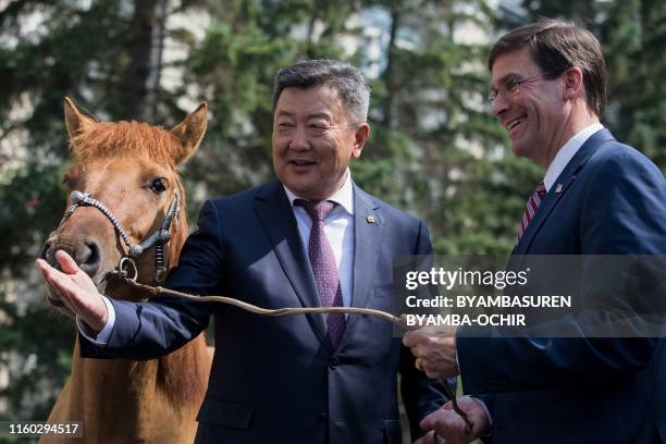 Secretary of Defense Mark Esper is presented a horse by Mongolia's Defence Minister Nyamaa Enkhbold in Ulaanbaatar, the capital of Mongolia on August...