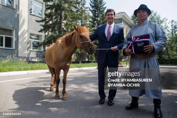 Secretary of Defense Mark Esper is presented a horse in Ulaanbaatar, the capital of Mongolia on August 8 during his visit to the country. - Esper was...
