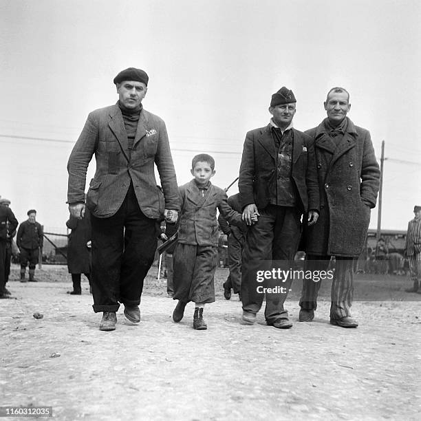 French prisoners Camille Sautereau , Pierre Mazel and commander Bellon walk with a 7-year-old child, who has been on the death list three times, in...