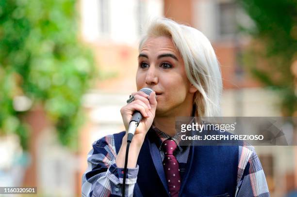 Singer-songwriter Ricky Godinez, known by his stage name Ricky Rebel, speaks to people attending the "Defend the Constitution Rally" at Lexington...