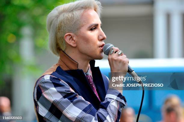 Singer-songwriter Ricky Godinez, known by his stage name Ricky Rebel, speaks to people attending the "Defend the Constitution Rally" at Lexington...