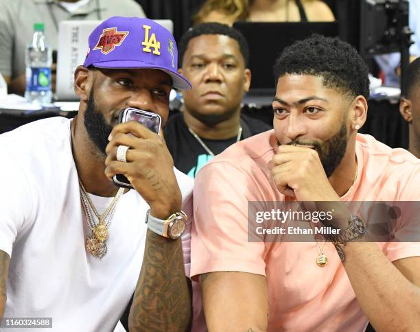 Players LeBron James and Anthony Davis talk as they watch a game between the New Orleans Pelicans and the New York Knicks during the 2019 NBA Summer...