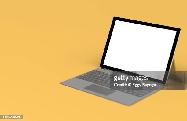 tablet with keyboard cover on yellow background - laptop studio shot stock pictures, royalty-free photos & images